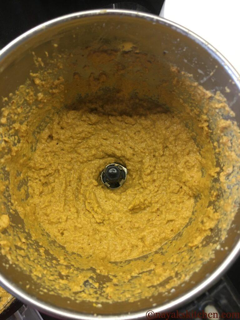 Grinding fried onion, coconut, dry masalas and tamarind to a fine paste in the mixie