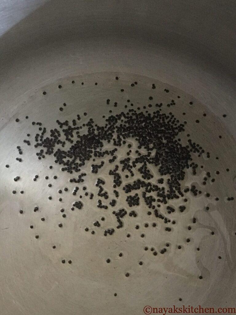 Adding mustard seeds to heated oil