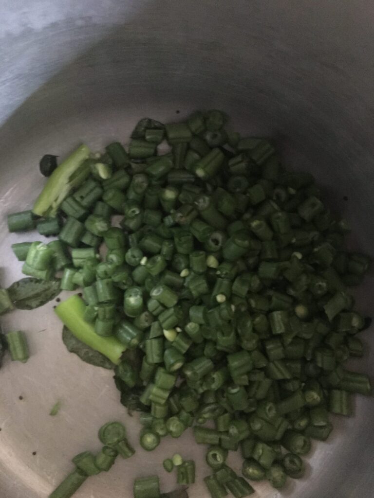Adding chopped french beans