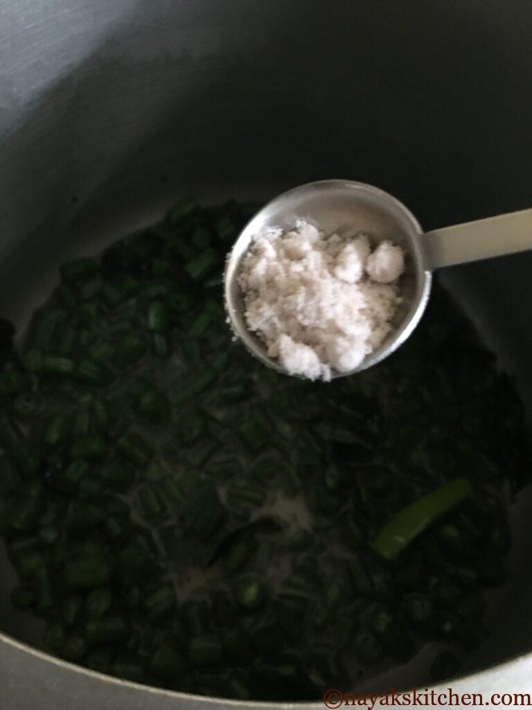 Adding salt to french beans sabzi
