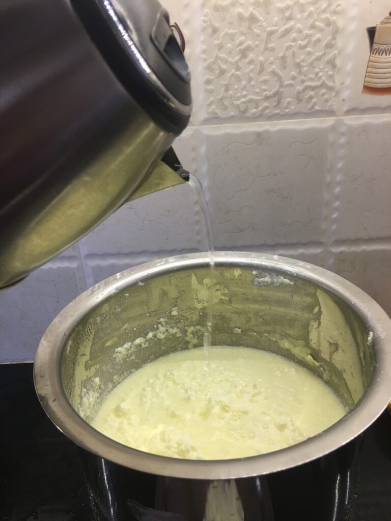 Adding warm water to set cream