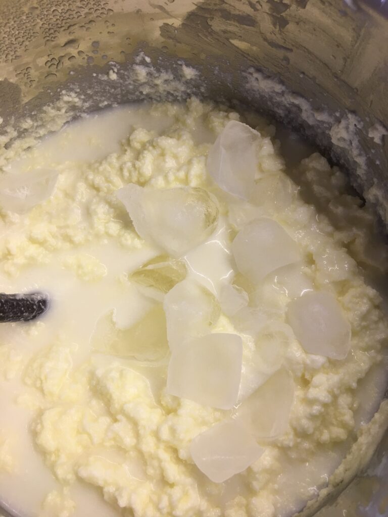 Adding ice cubes to churned cream