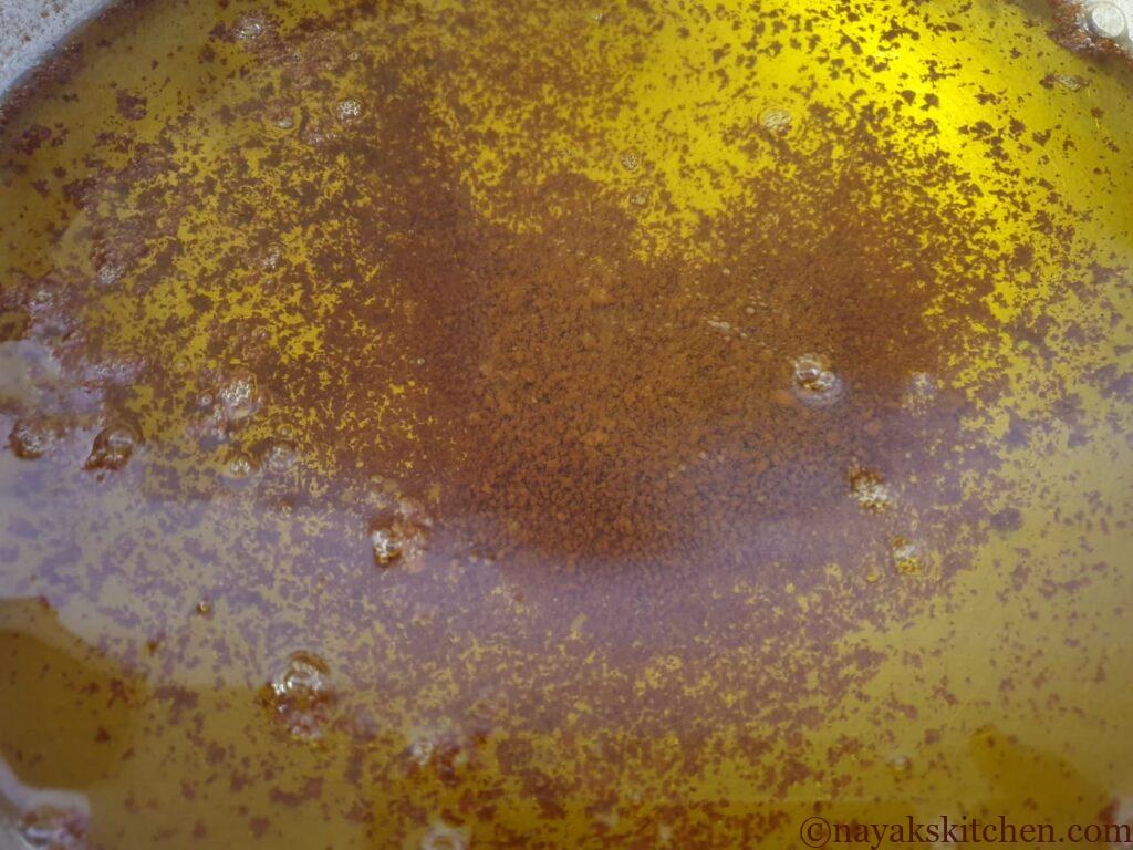 Pure ghee with browned milk solids settled at the bottom