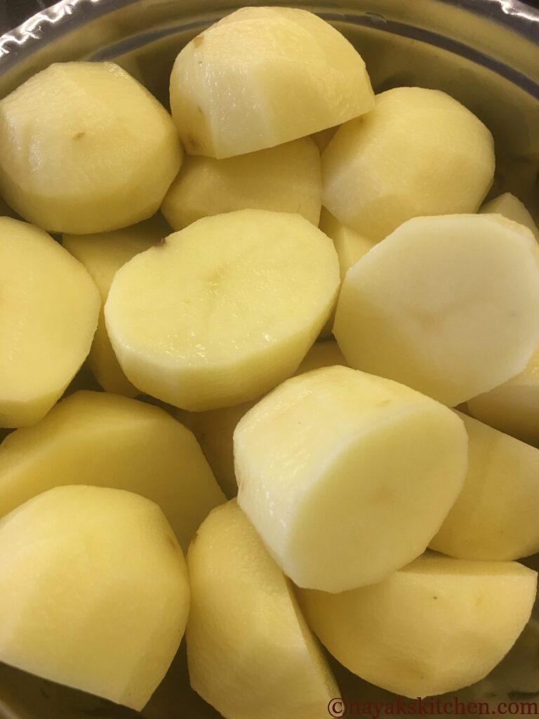 Peeled and halved potatoes for beetroot cutlet