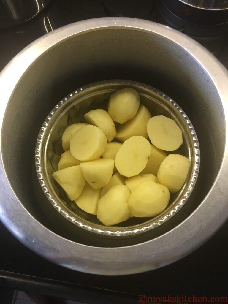 Potatoes placed in a pressure cooker for steaming