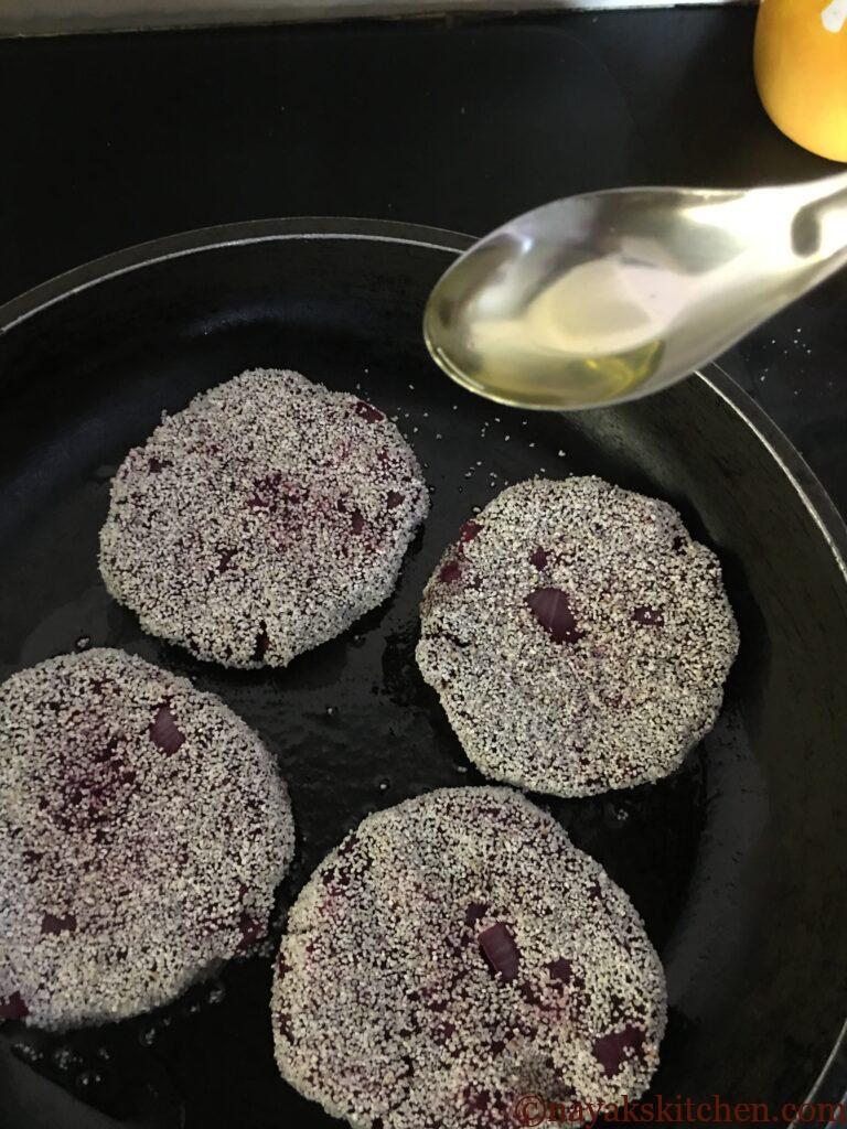 Adding oil while frying the beetroot cutlets