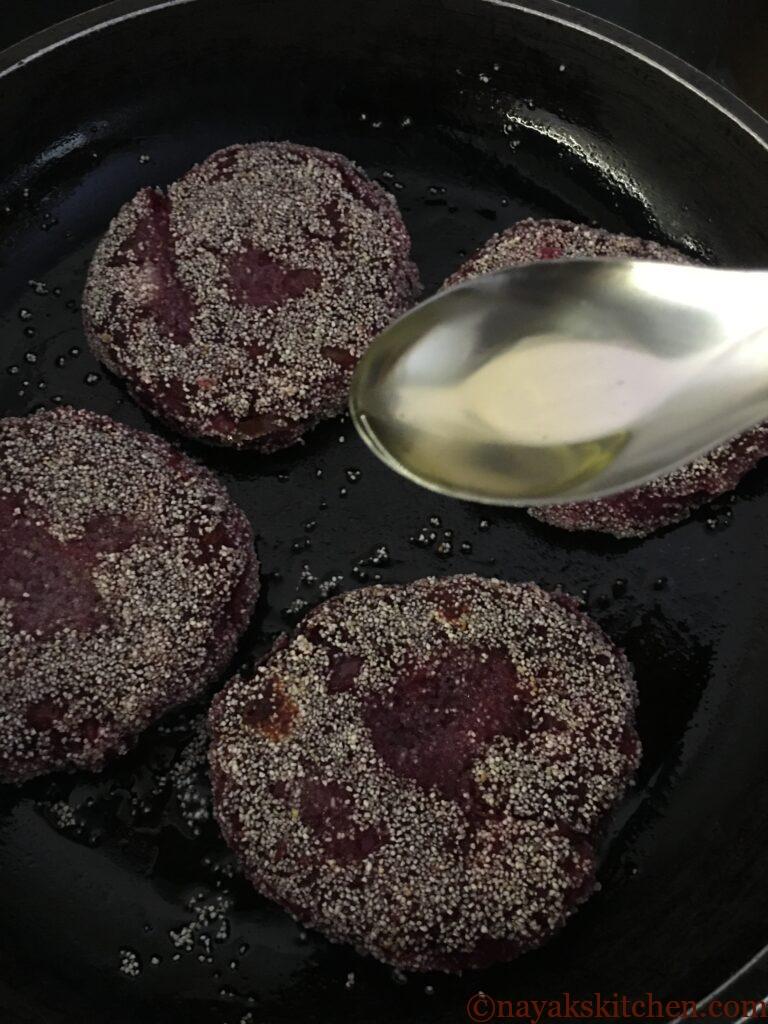 Adding oil to fry other side of beetroot cutlets