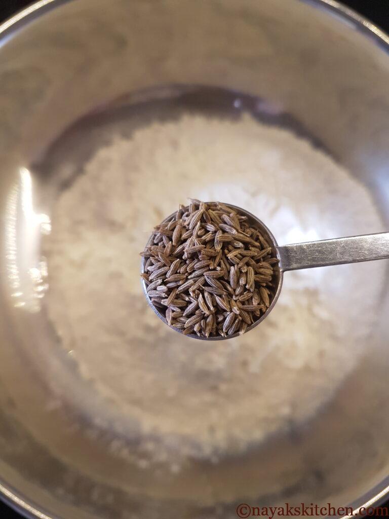 Adding jeera to mixture
