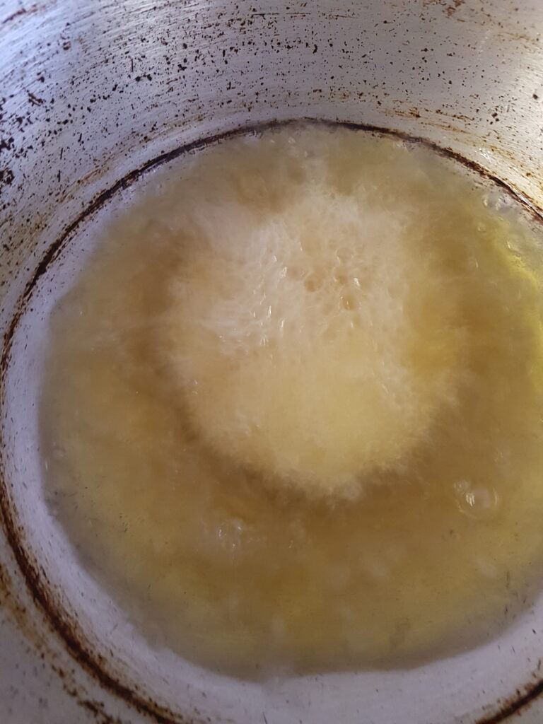 Sliding the poori in heated oil