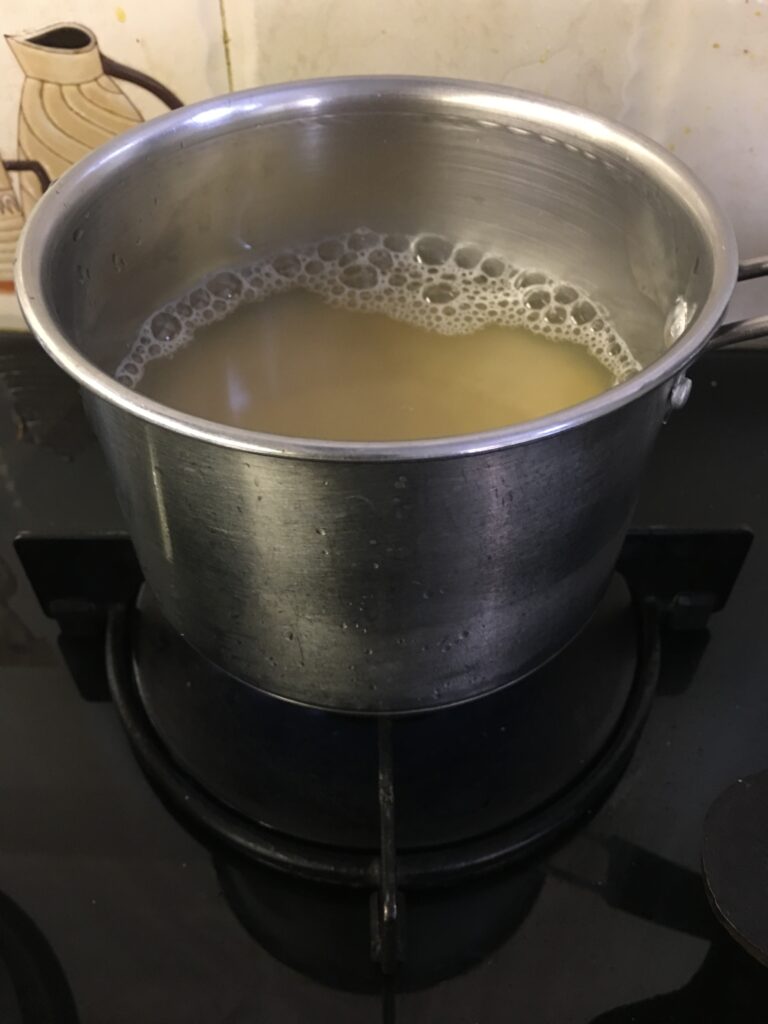 Placing dal to cook on gas top