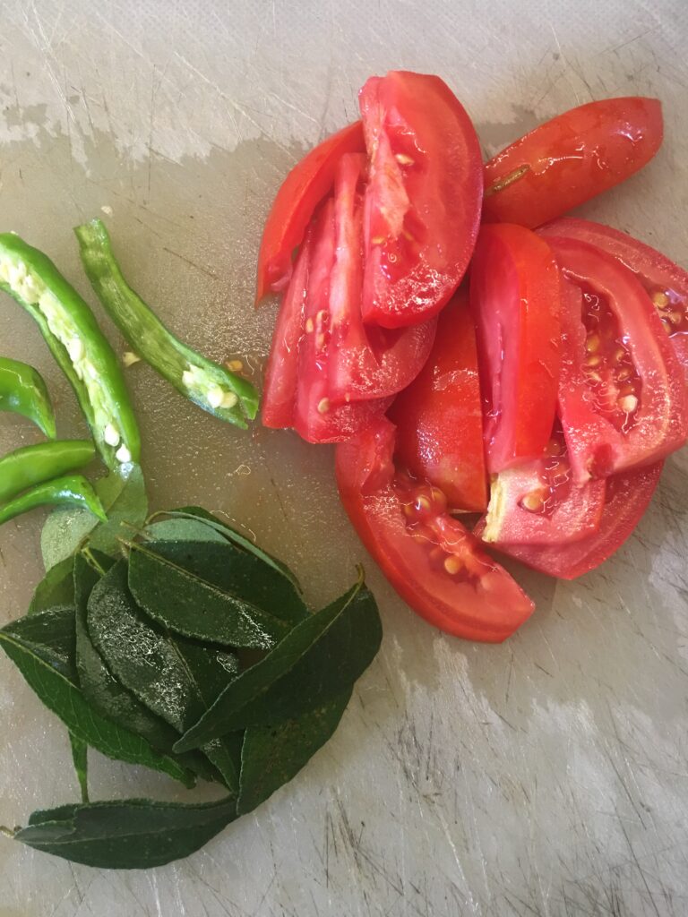 Tomatoes, green chillies, curry leaves for dal