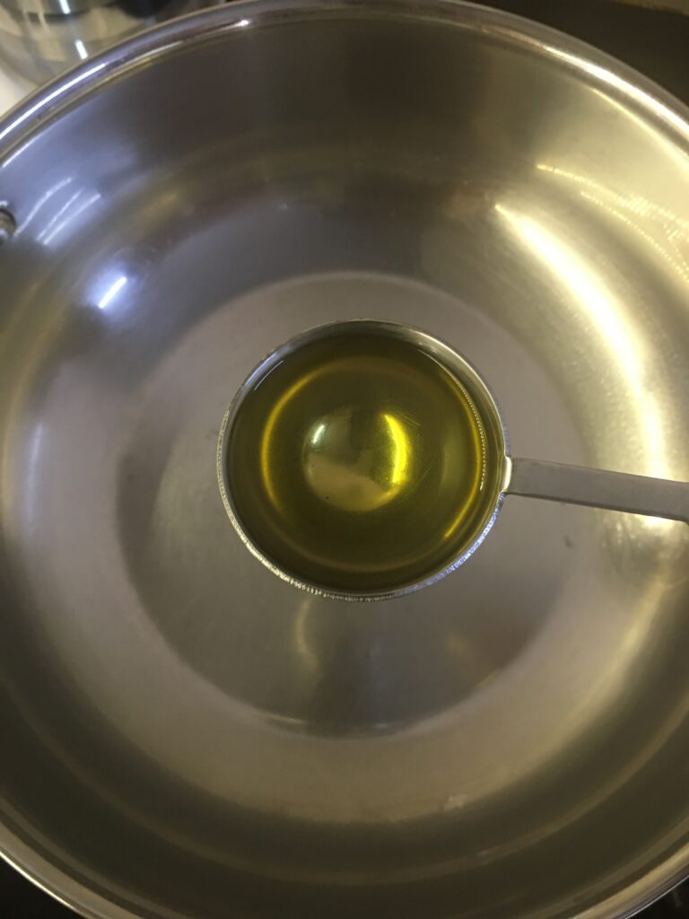 Adding oil to kadhai