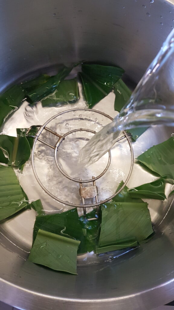 Adding water to steamer to steam patolis