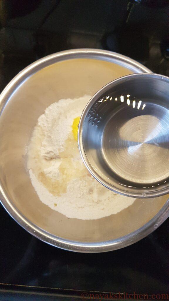 Adding water slowly to make a thick paste