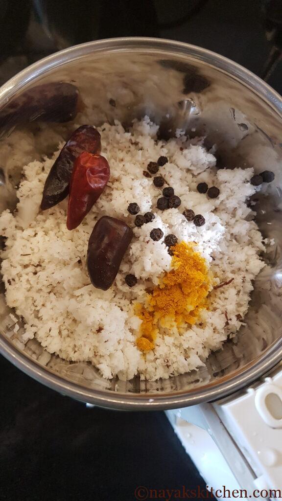 Grinding coconut red chillies pepper and turmeric for chanyachi usal