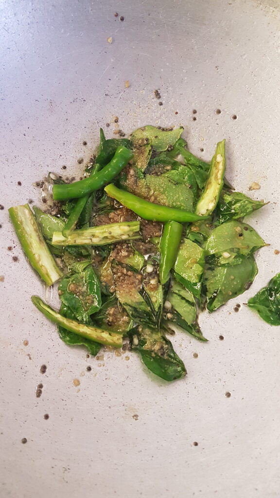 Adding slit green chillies