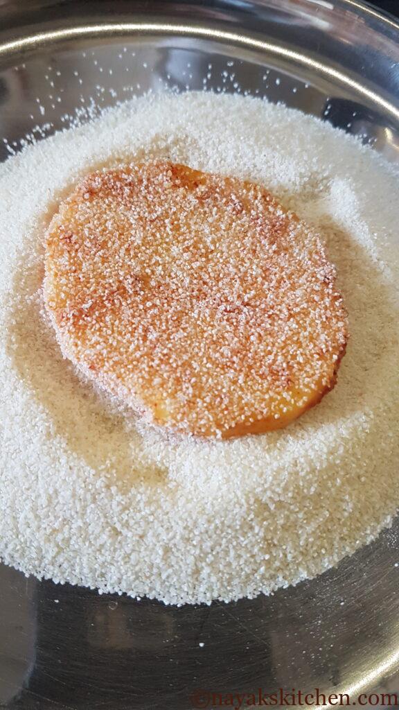 Coating batat fodi (potato slices) with rava or semolina