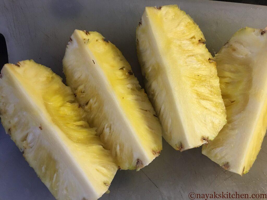Cutting the pineapple into four pieces for pineapple jam
