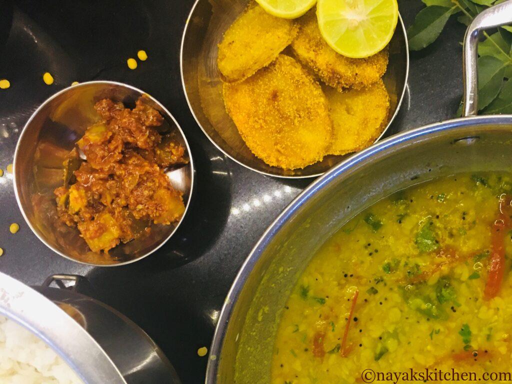 Batat fodi served with dal-rice and pickle