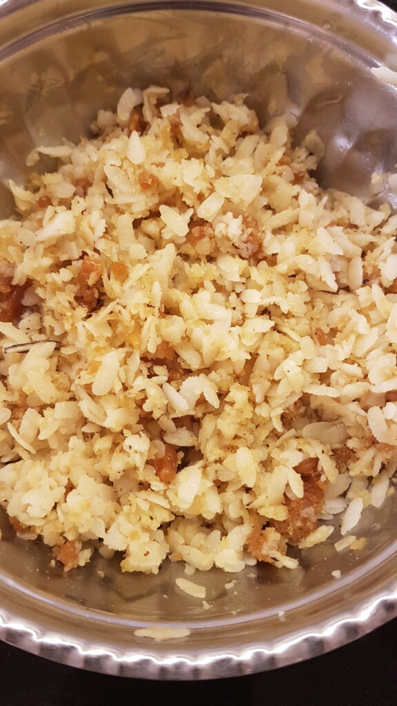 Mixing coconut, jaggery and poha well