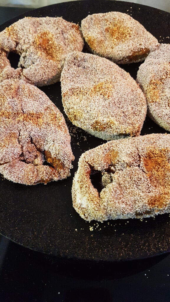 Frying kingfish on an iron tawa