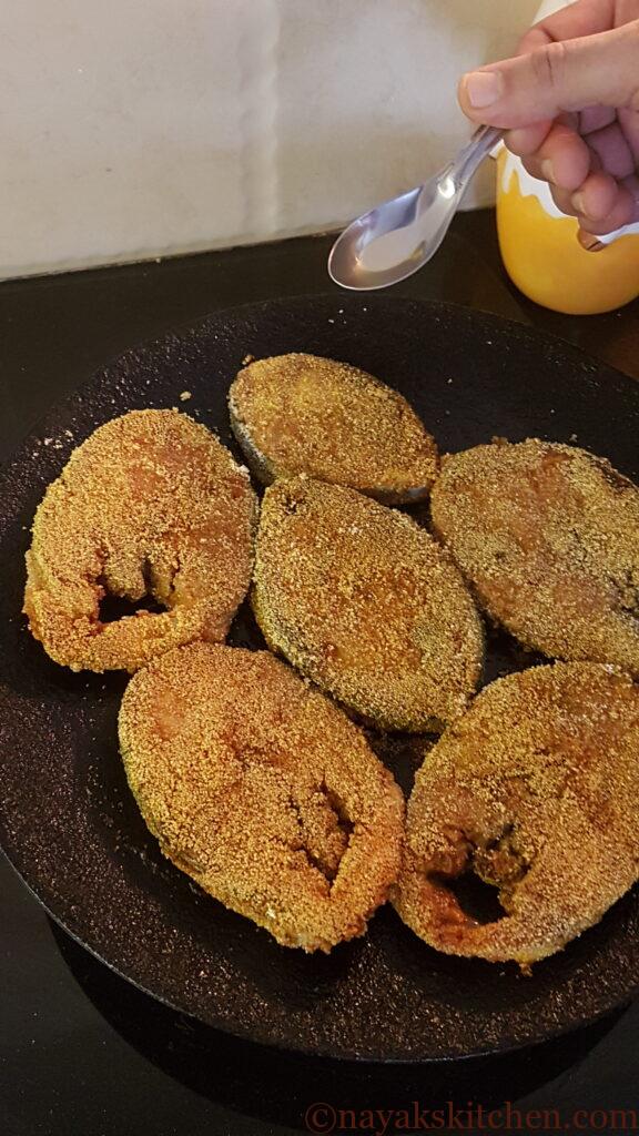 Pouring oil along the sides of kingfish