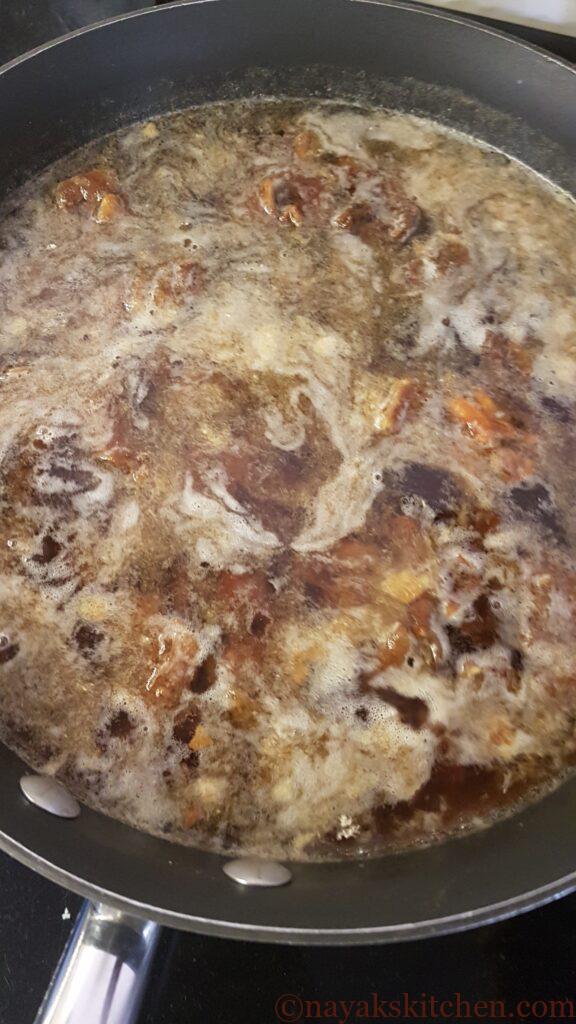 Bringing tamarind, dates and jaggery to a boil