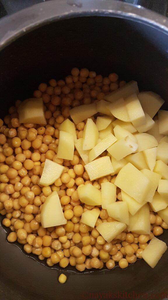 Adding chopped potato to soaked white peas