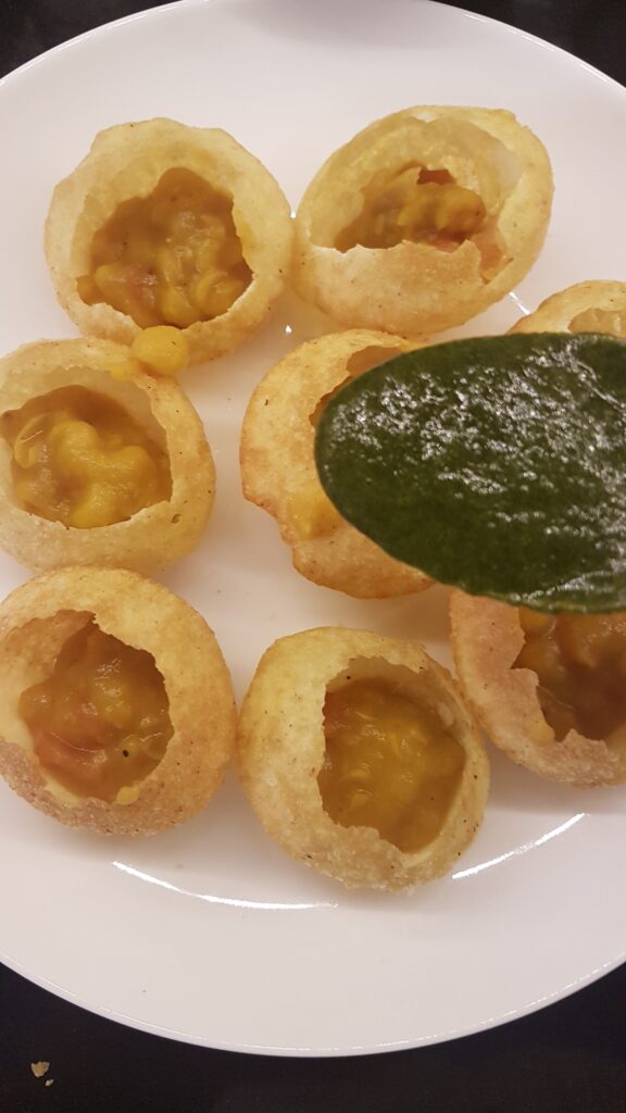 Adding green chutney to puri