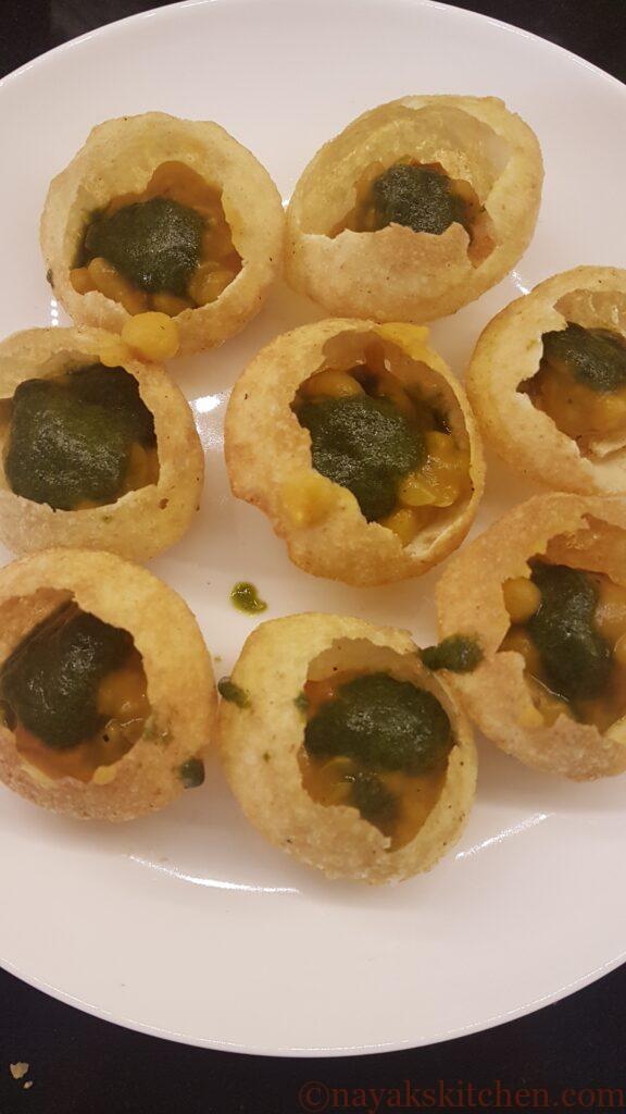 Adding green chutney to puri