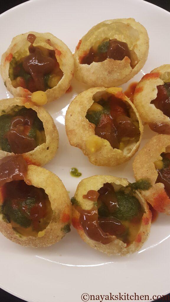 Adding tamarind chutney to puri