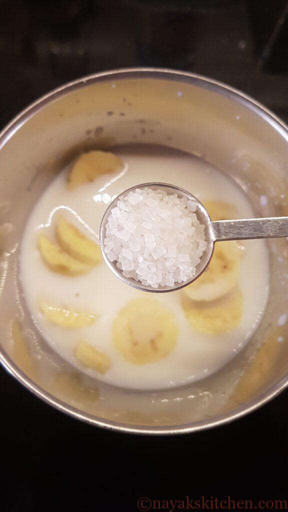 Adding sugar to milk and sliced bananas