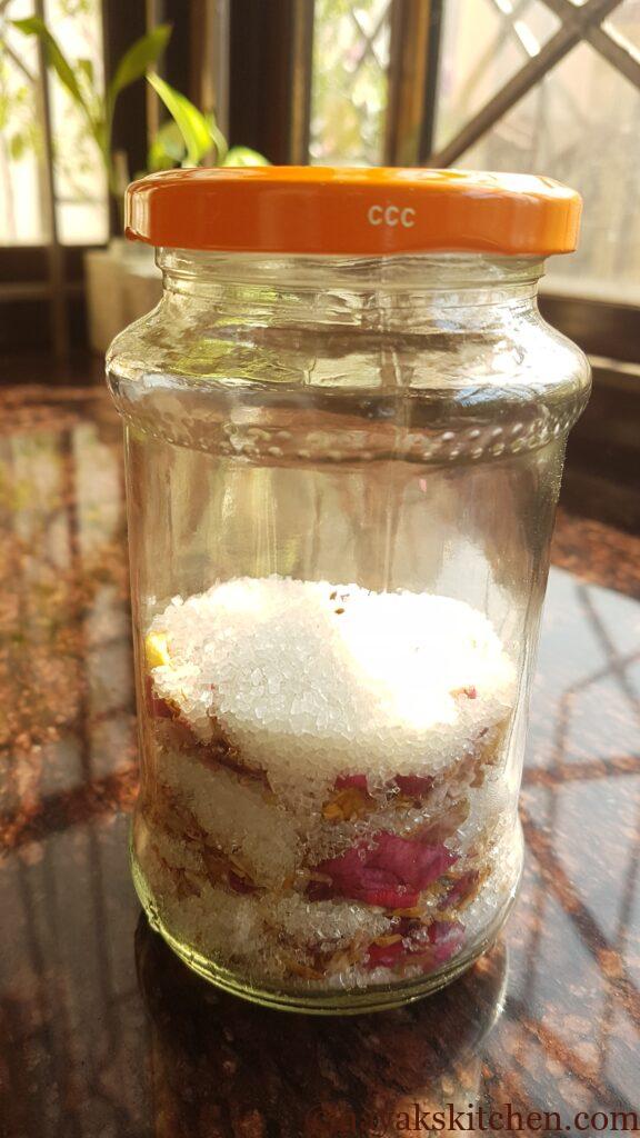 Sun-drying layered rose petals and sugar