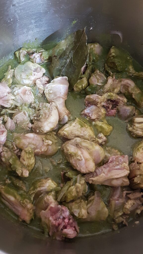 Mixing chicken and green masala well.