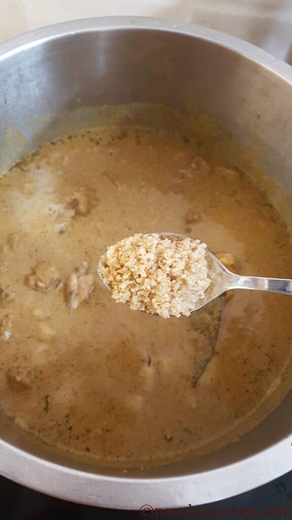 Adding salt to chicken xacuti.