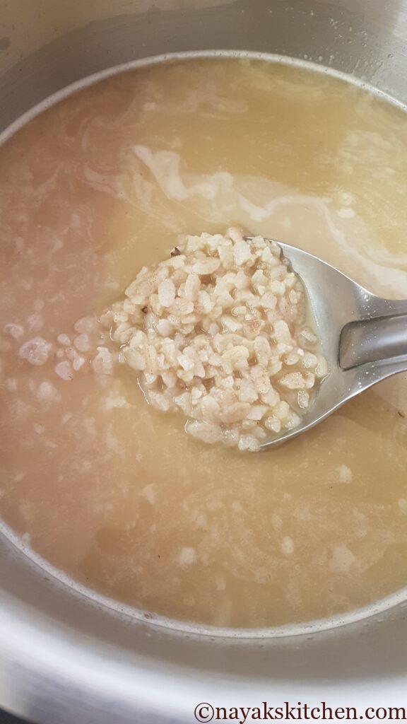 Stirring the coconut milk, jaggery, poha mixture well