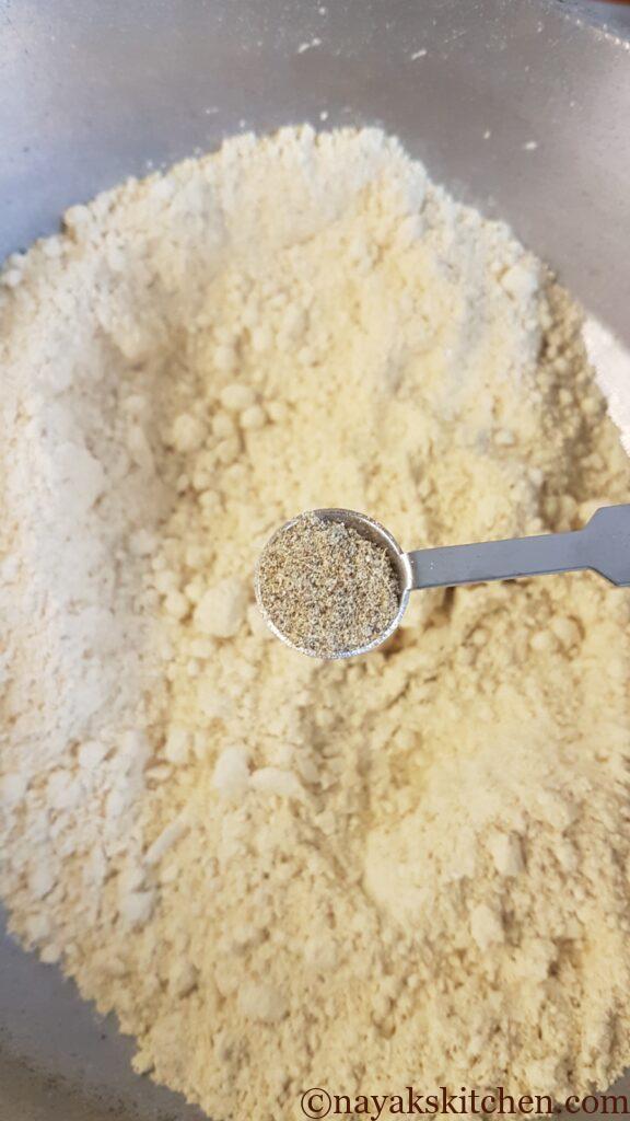 Adding cardamom powder to flour