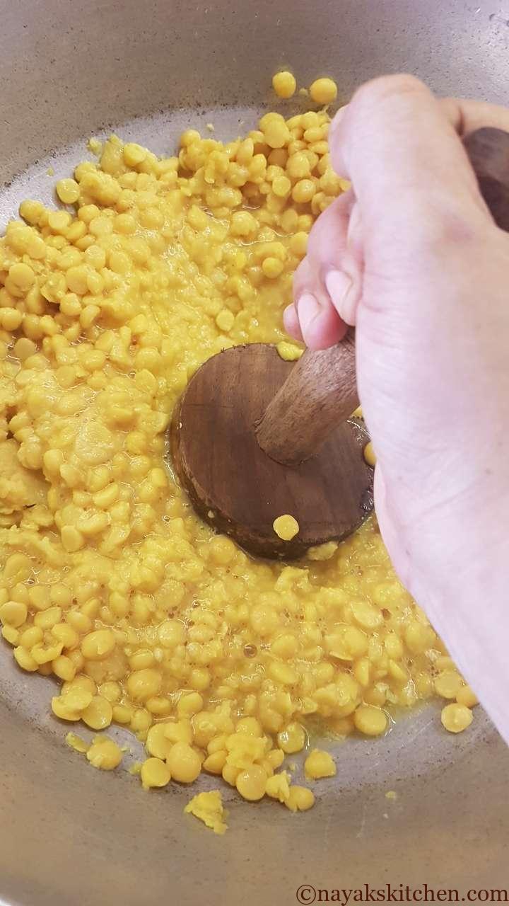 Mashing the cooked dal