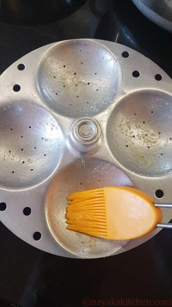 Applying ghee to idli plates