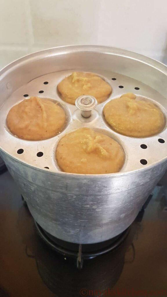 Placing the idli plates in the steamer