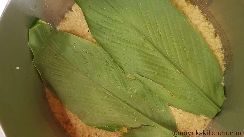 Turmeric leaves are placed on the tavsali batter.