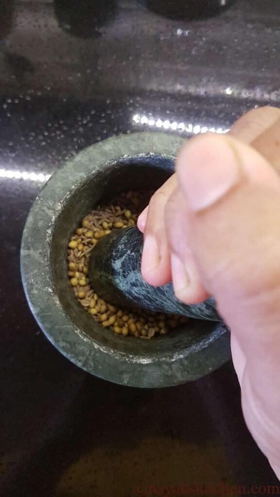 Pounding spices in a mortar pestle
