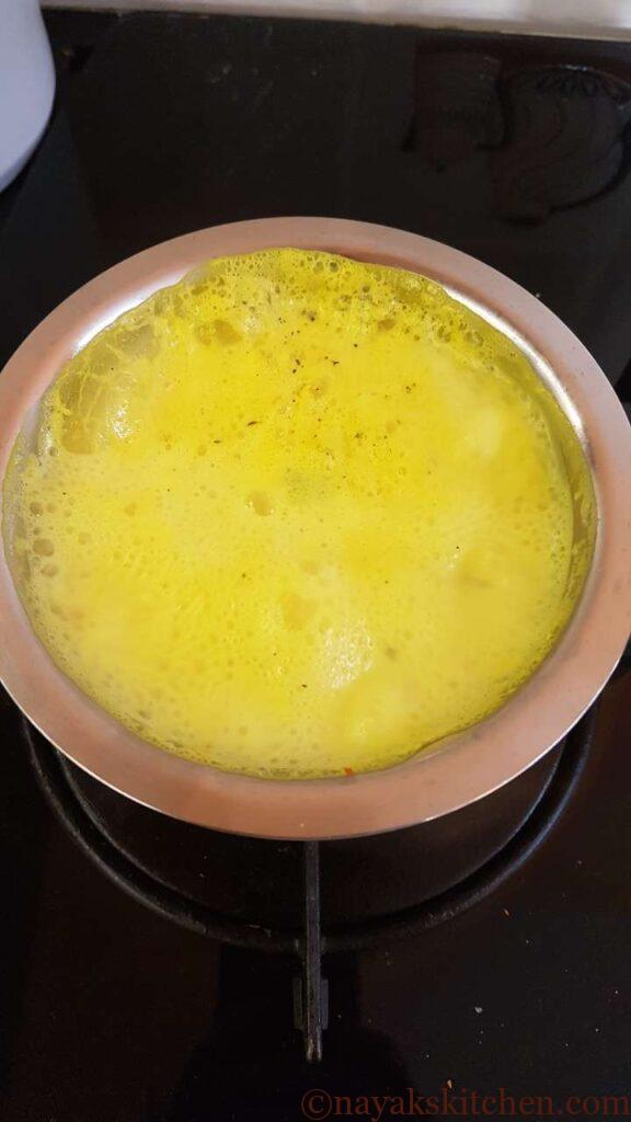 Boiling turmeric and milk