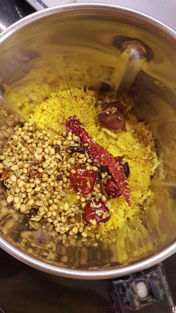 Roasted coconut and spices in a mixie jar.