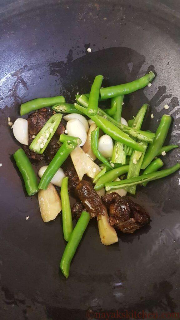 Adding slit green chillies