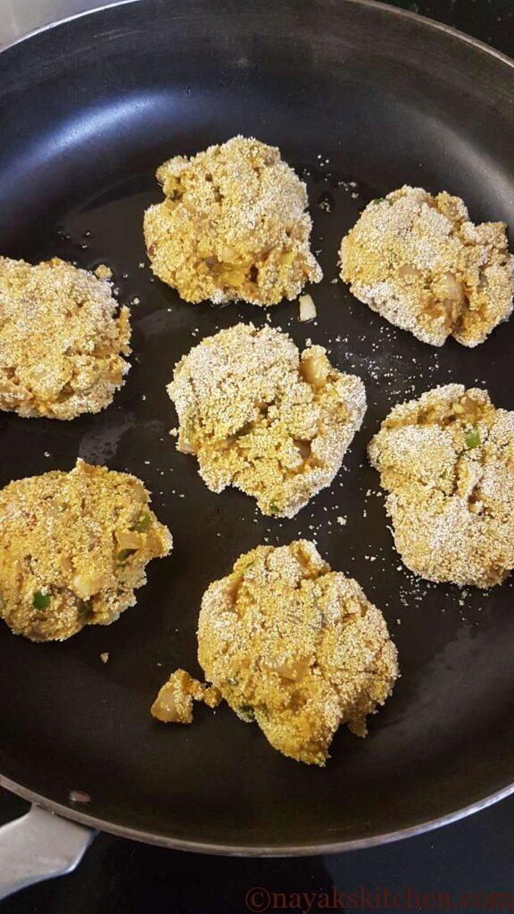 Placing rava coated cutlets in the pan