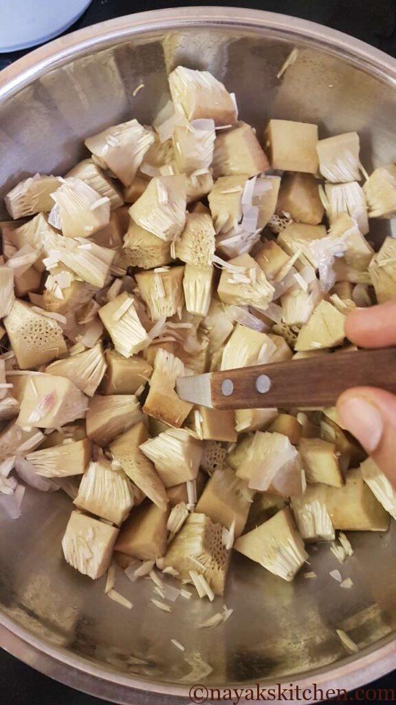 Checking if jackfruit pieces have cooked