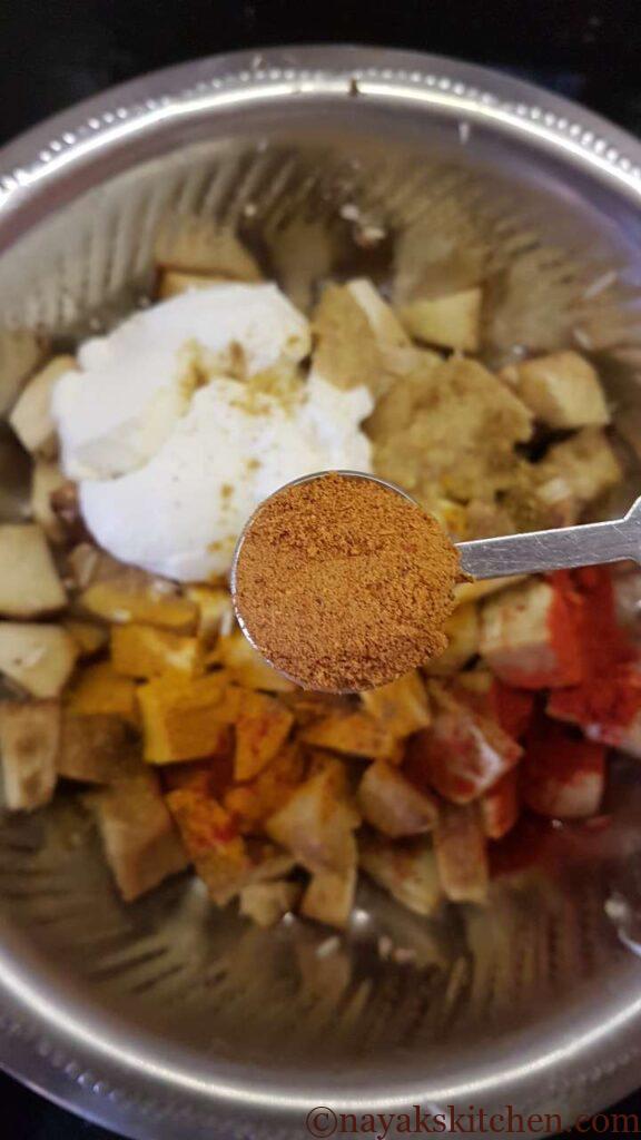 Adding biryani masala to jackfruit pieces