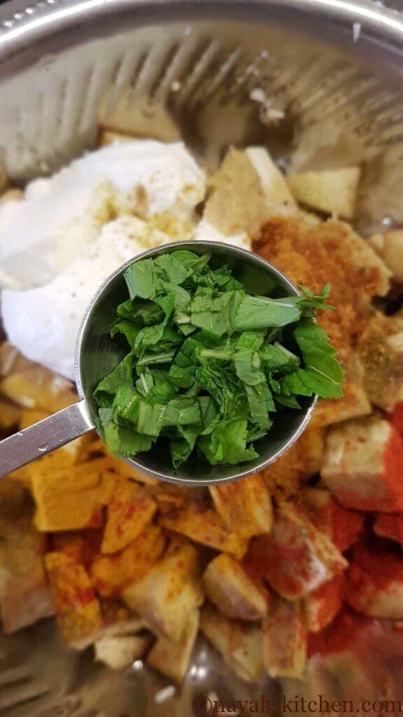 Adding mint leaves to jackfruit pieces