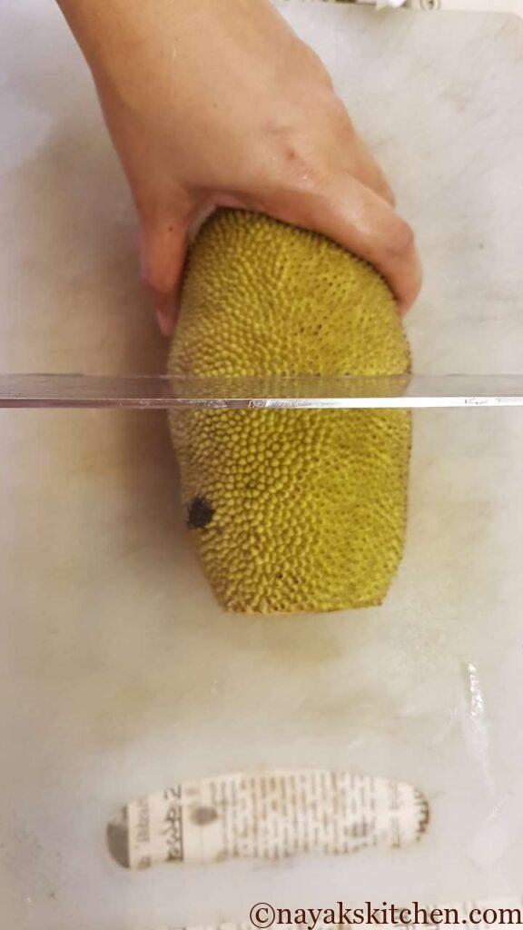Cut the raw jackfruit into 2 halves